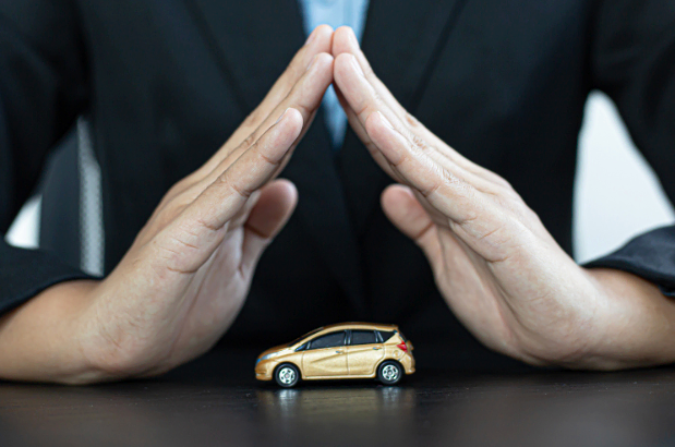 Man covering toy car